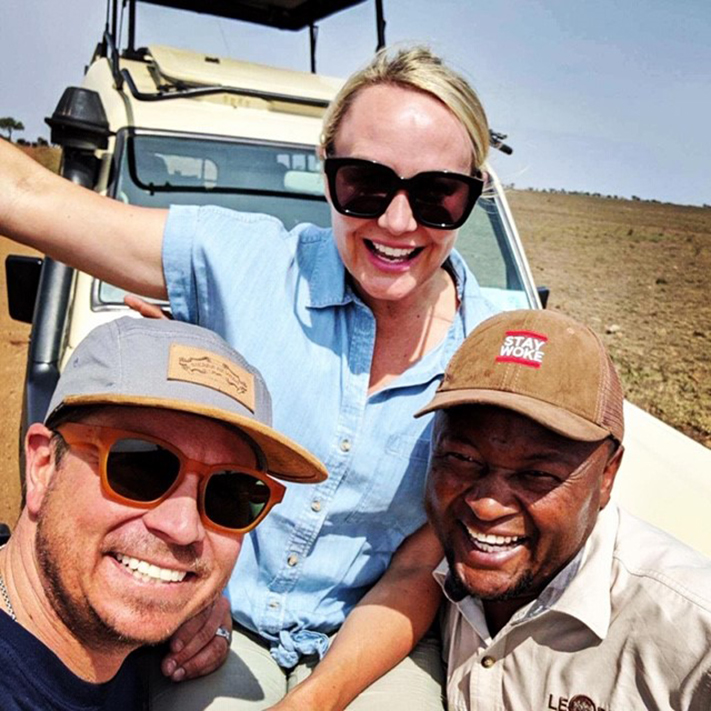 Woman and two men taking selfie on safari 