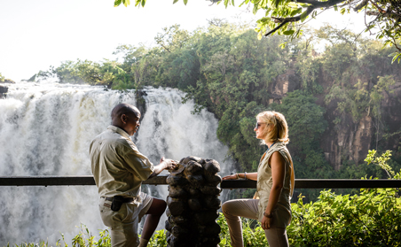 Guest with guide at the Victoria Falls, Zimbabwe.  